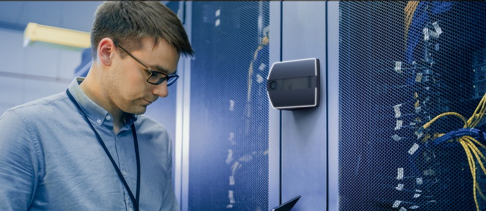A man accesses a data center with a security camera outside.