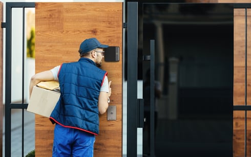 Man using intercom at exterior door with Rock X