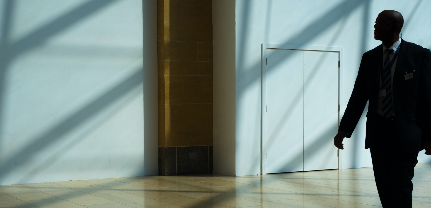 photo of man standing close to a door
