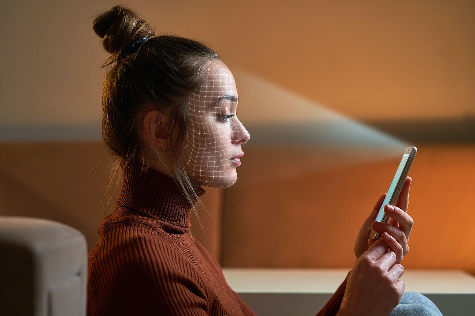 Woman using facial biometrics to unlock her mobile phone