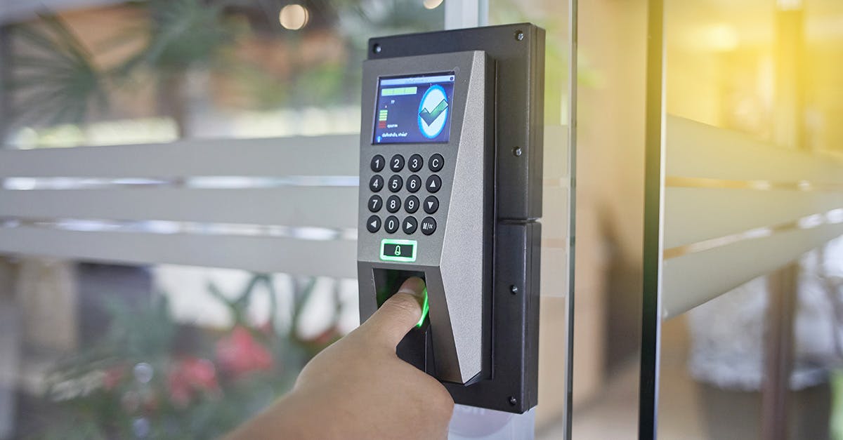 Person using fingerprint biometrics to enter a secured space