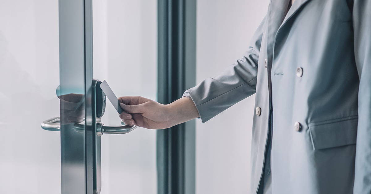 Person using a digital key card to access a room.