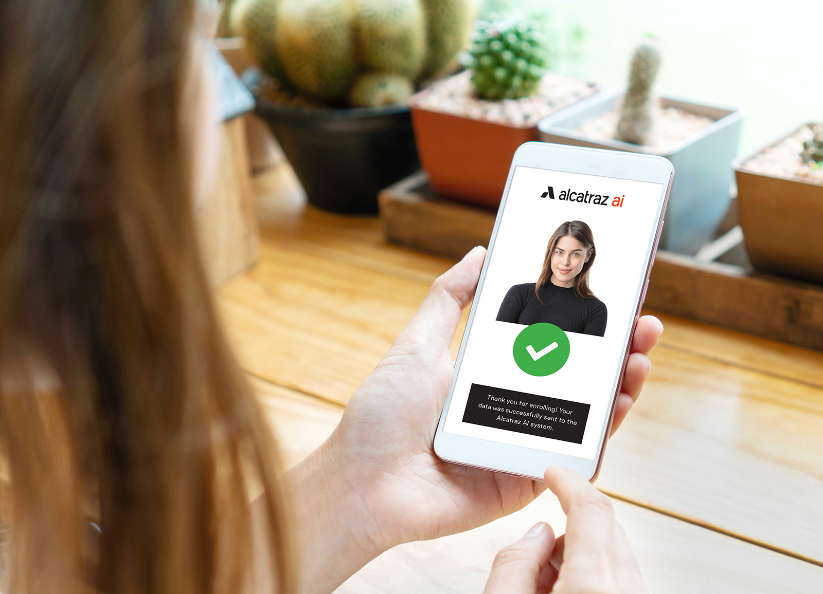 Woman using mobile phone to enroll in Alcatraz AI